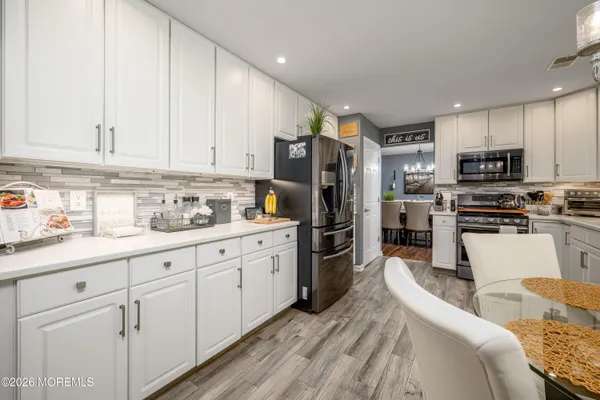 a kitchen with stainless steel appliances granite countertop a refrigerator sink and cabinets