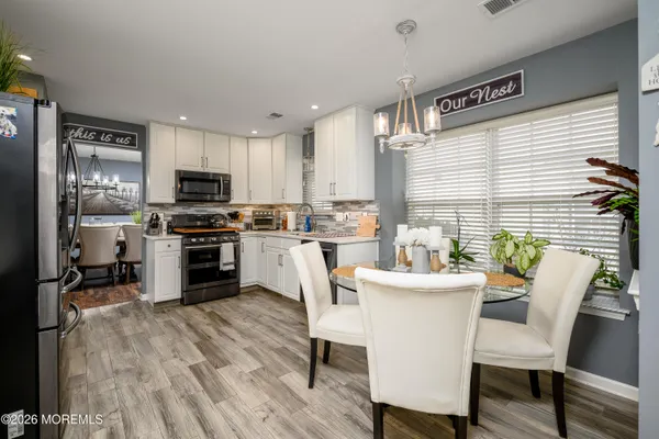 a kitchen with sink a microwave cabinets and stainless steel appliances