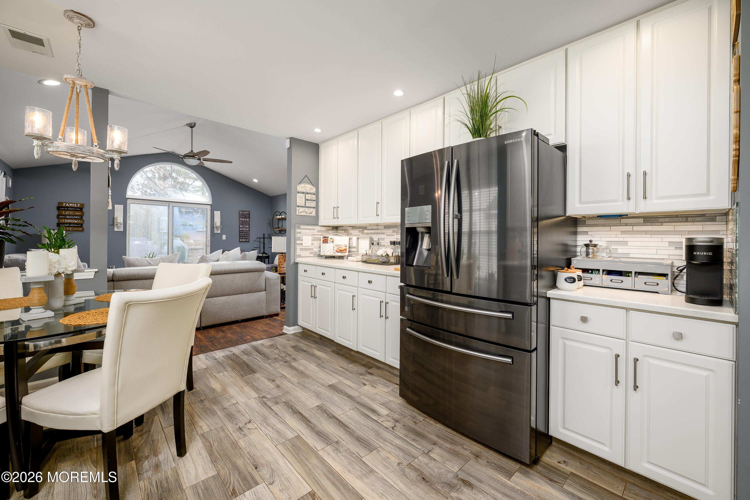 26 Ivy Hill Road Lakewood, NJ 08701 - Photo 16 of 46 a kitchen with a refrigerator a stove a sink and white cabinets with wooden floor