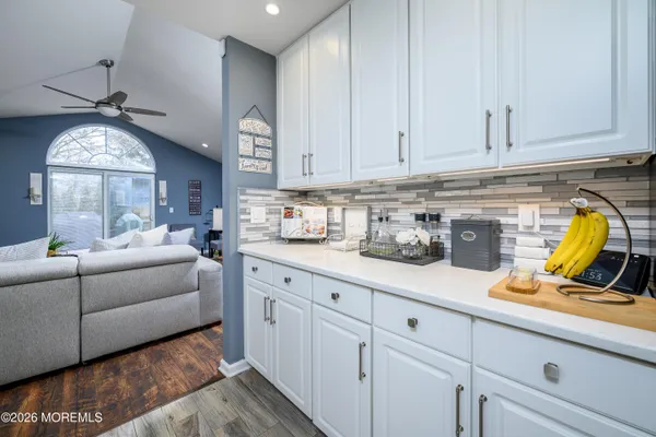 a kitchen with cabinets a window and appliances