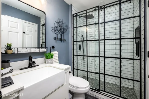 a bathroom with a sink toilet and shower