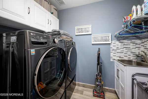 a view of a storage and utility room with washer and dryer