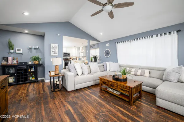 a living room with furniture and wooden floor