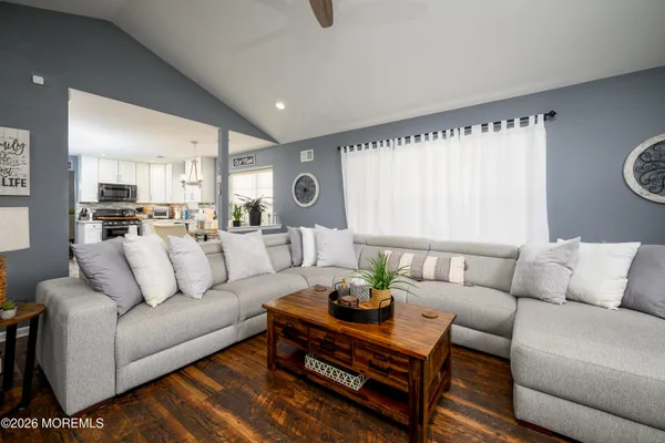 a living room with furniture and wooden floor