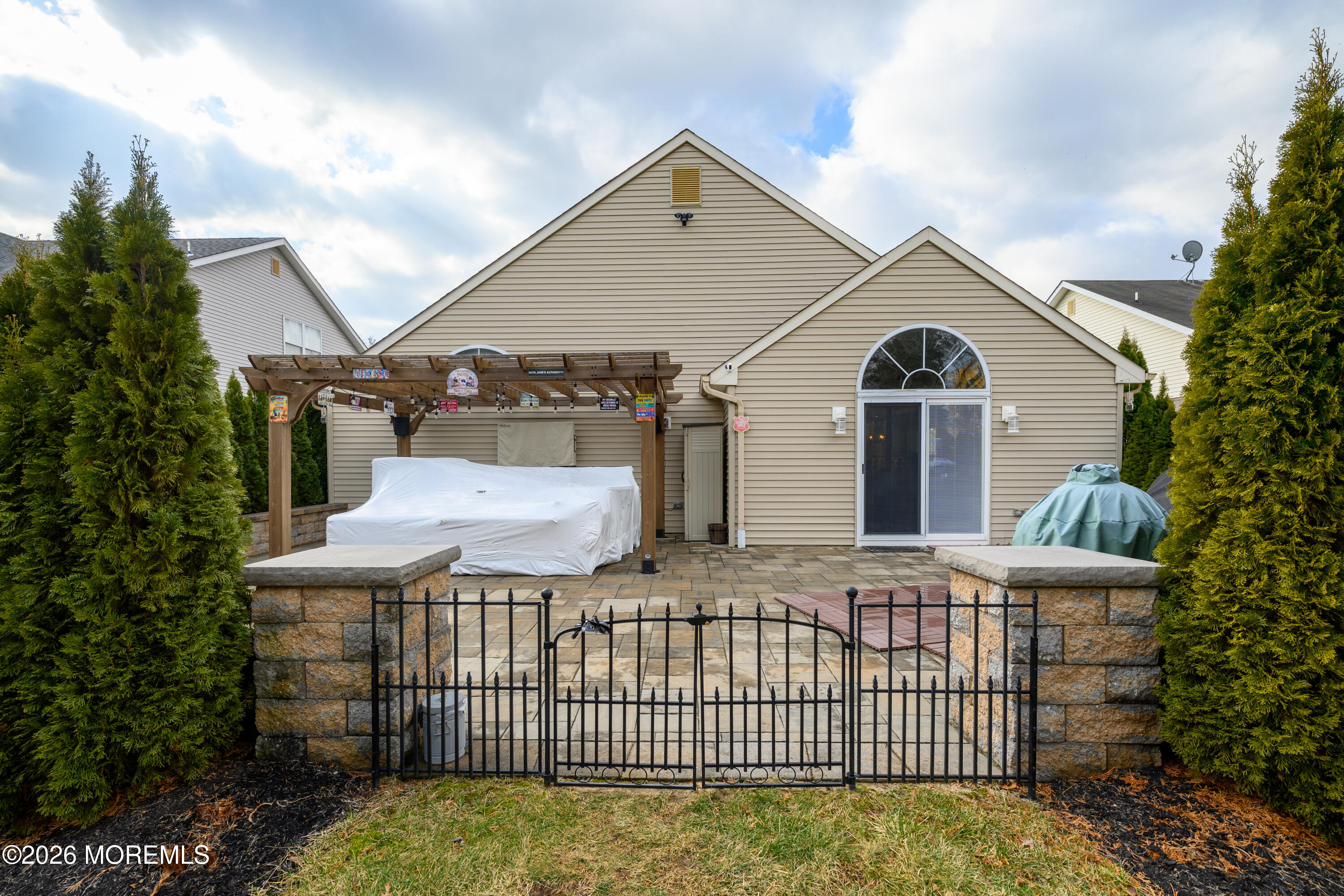 26 Ivy Hill Road Lakewood, NJ 08701 - Photo 38 of 46 a view of a brick house with a small yard and large trees