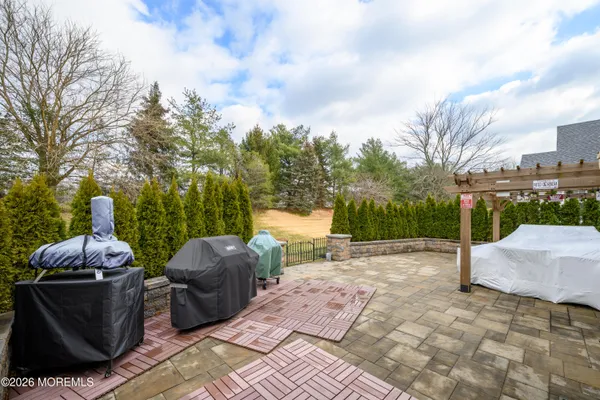 a backyard of a house with table and chairs