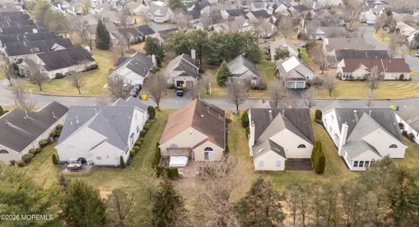 an aerial view of residential houses with outdoor space and swimming pool