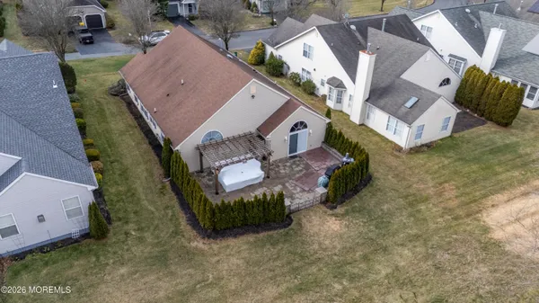 an aerial view of a house with garden space and street view