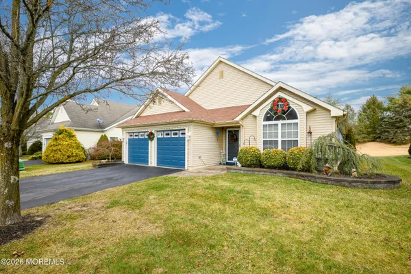 a view of a house with a yard and garage