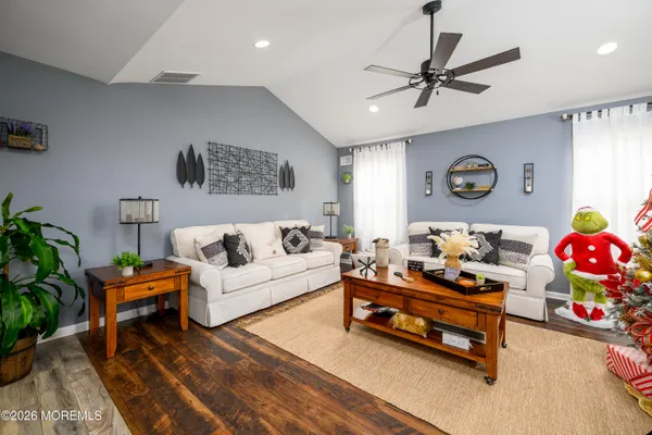 a living room with furniture and wooden floor