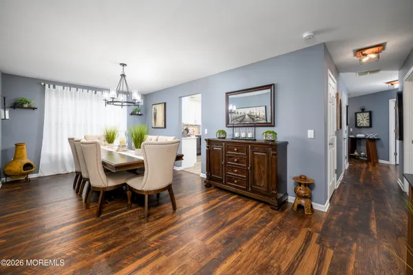 a view of a dining room with furniture and wooden floor