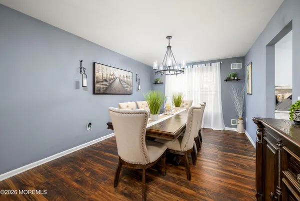 a view of a dining room with furniture window and wooden floor