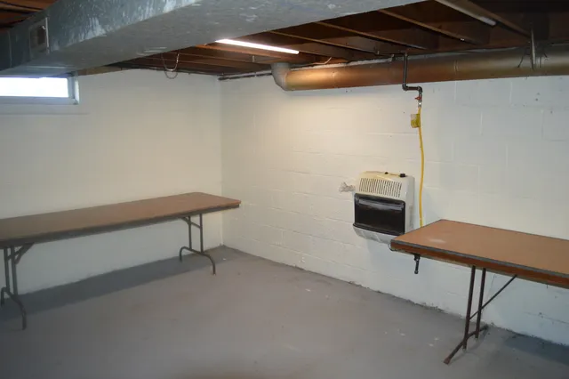 a view of storage and utility room with racks on the wall