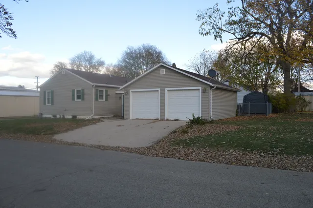 a front view of house with yard and trees around