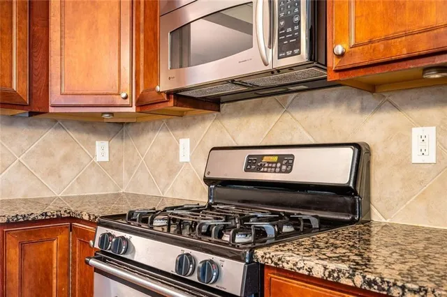 a stove top oven sitting inside of a kitchen