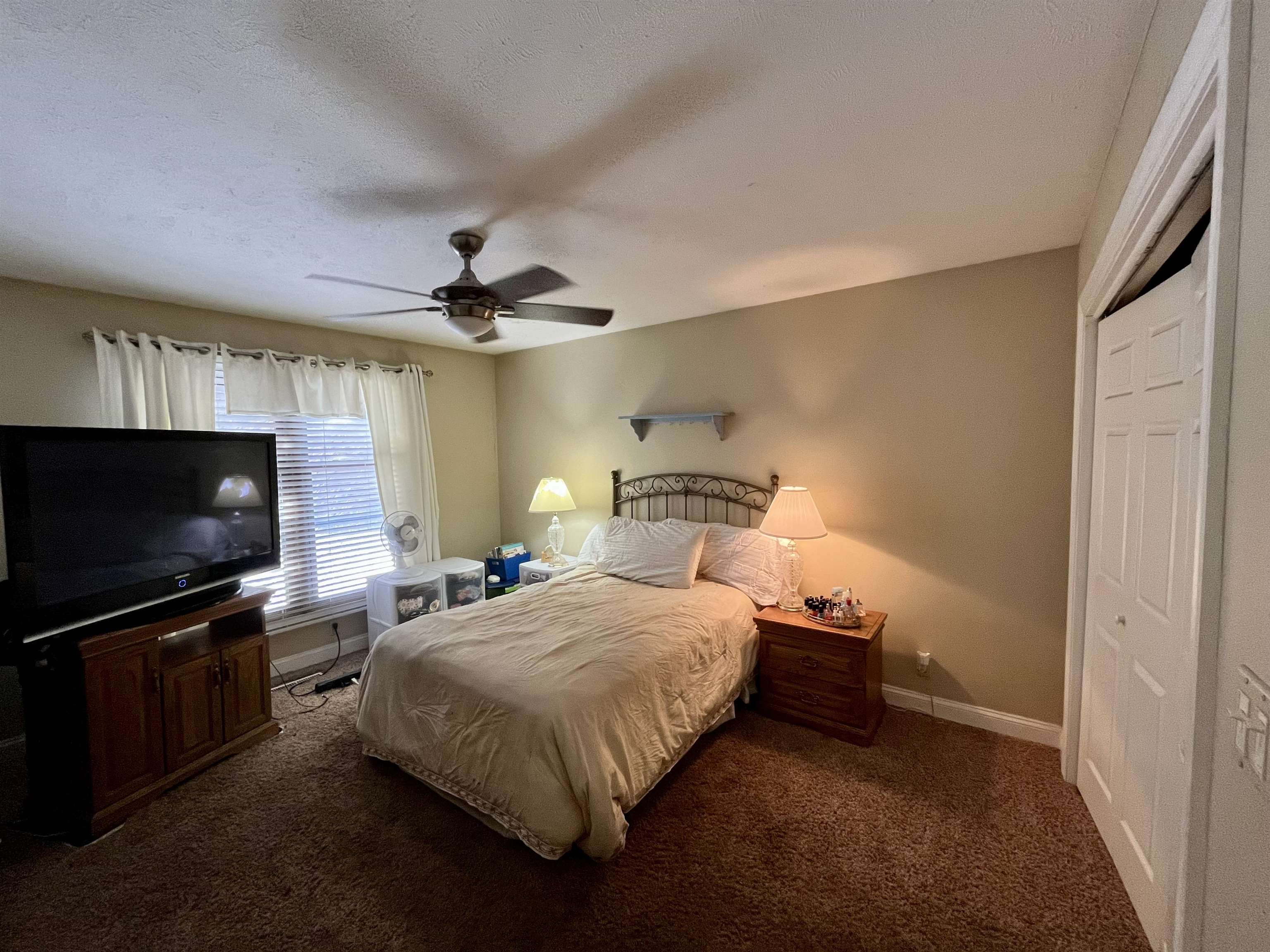 5051 Woodlake Drive Loves Park, IL 61111 - Photo 13 of 20 a bedroom with a bed and a flat tv screen on the dresser