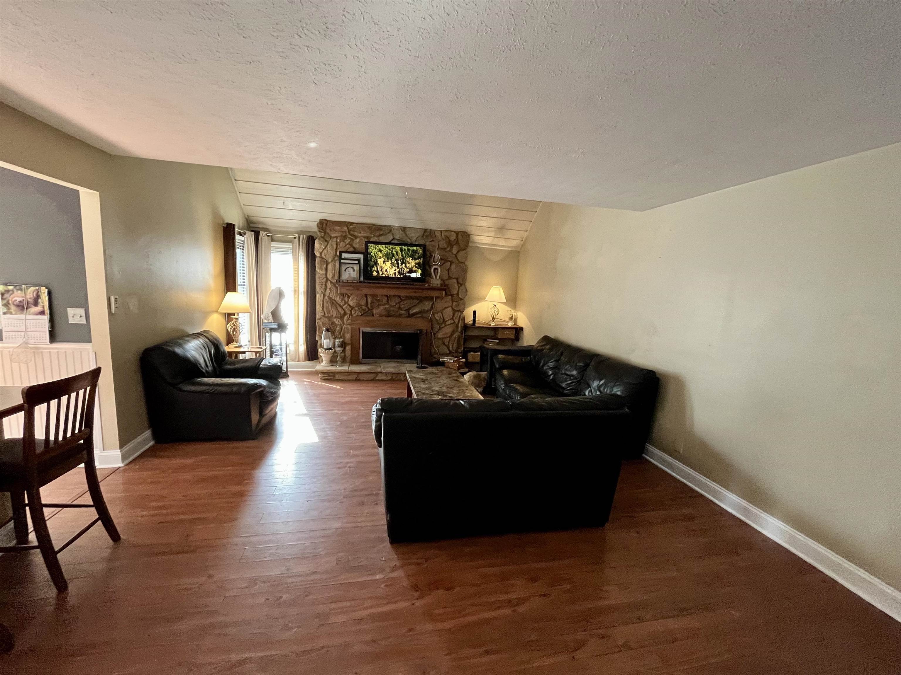 5051 Woodlake Drive Loves Park, IL 61111 - Photo 7 of 20 a living room with furniture and a flat screen tv