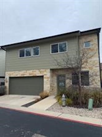 a front view of a house with garage