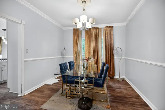 a view of a dining room with furniture and chandelier