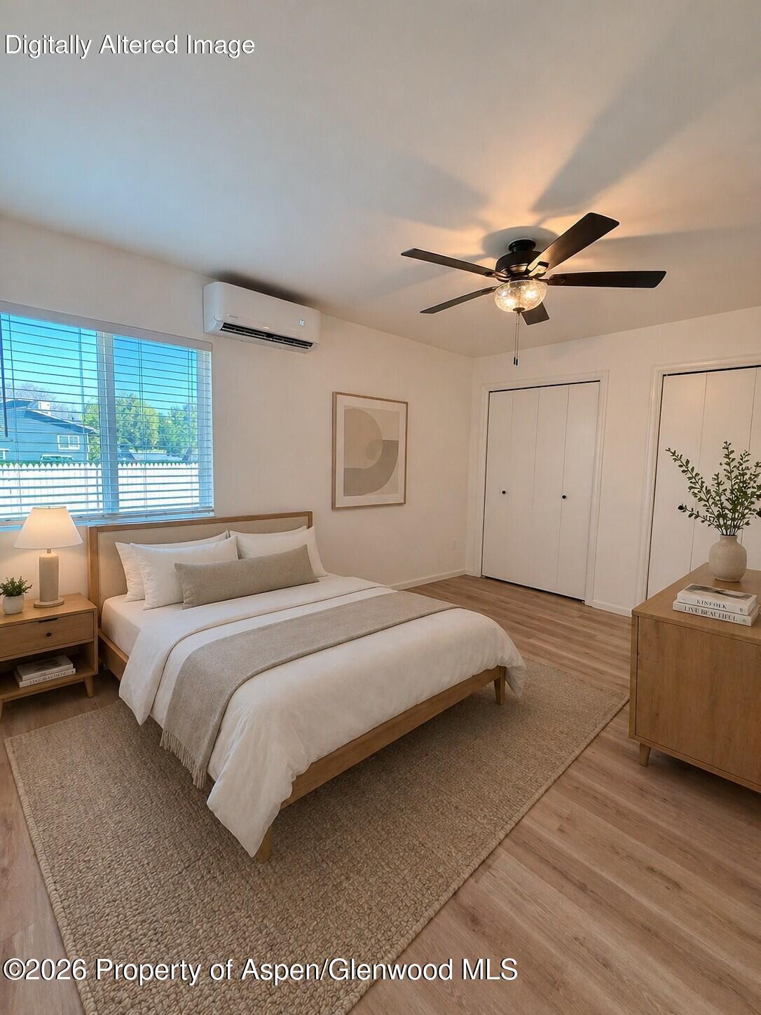 942 West 5th Street Rifle, CO 81650 - Photo 13 of 23 a bedroom with a large bed and a chandelier