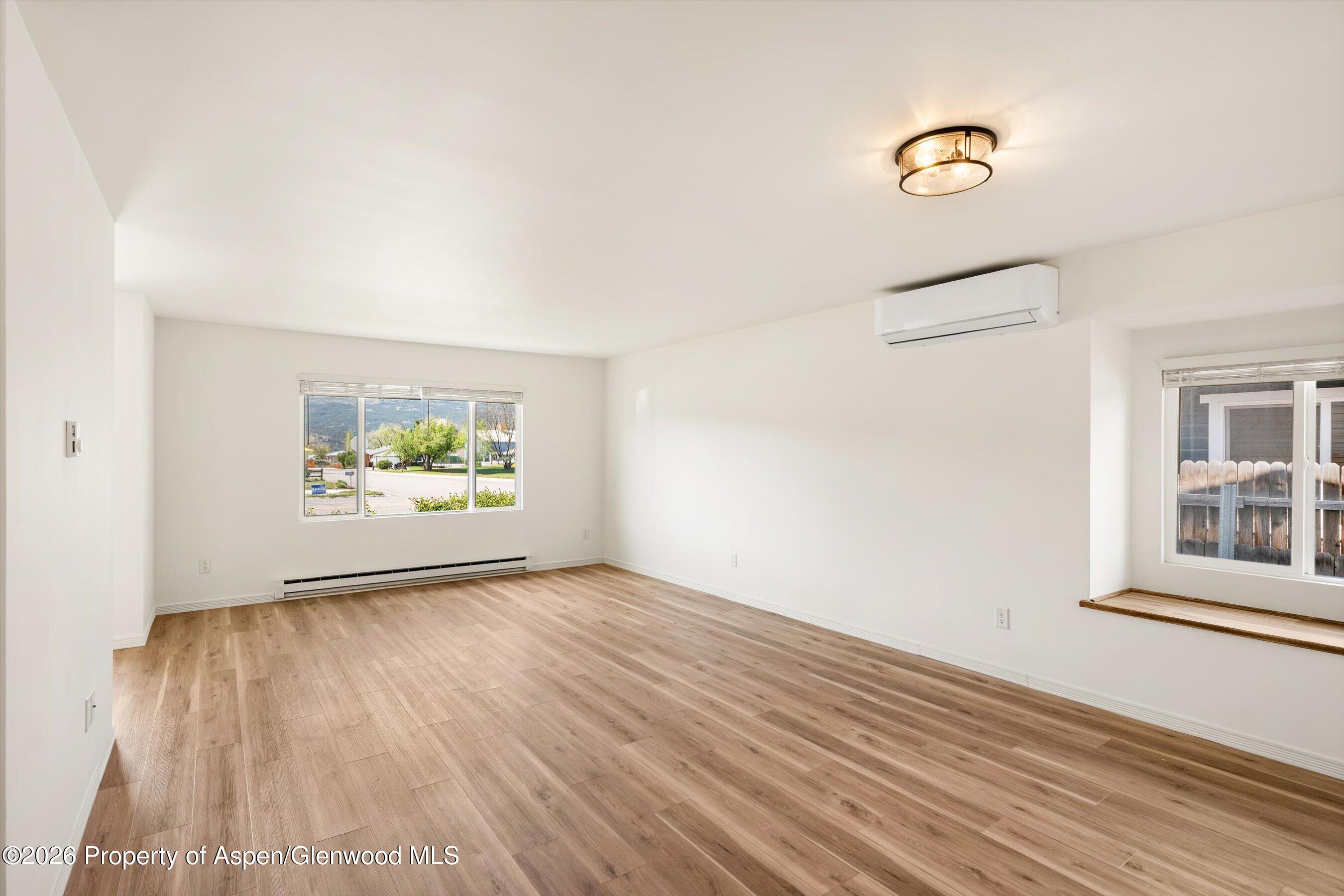 942 West 5th Street Rifle, CO 81650 - Photo 5 of 23 a view of an empty room with a window and wooden floor