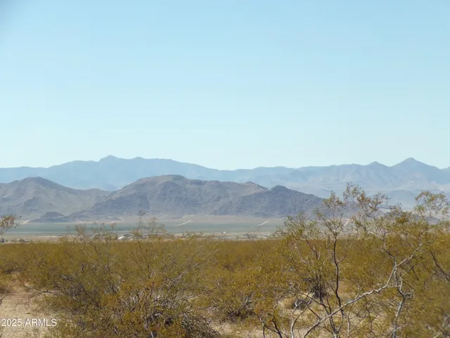 a view of a mountain range in a cloudy sky