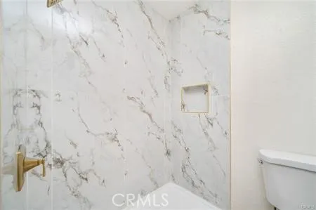 a view of a room that has a painting on the wall