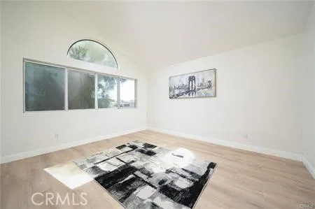 a view of a room with wooden floor and window