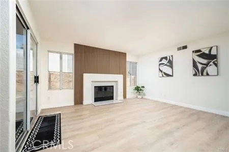 a living room with a fireplace and windows