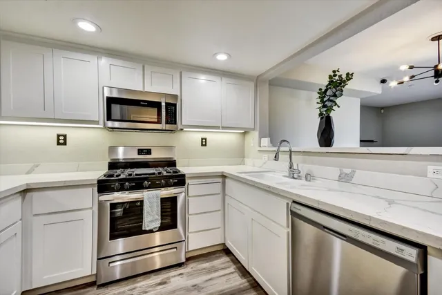 a kitchen with a sink stove and microwave