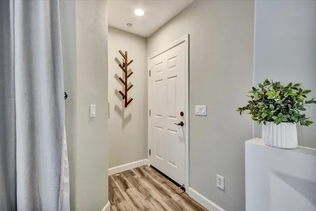 a view of an entryway with wooden floor