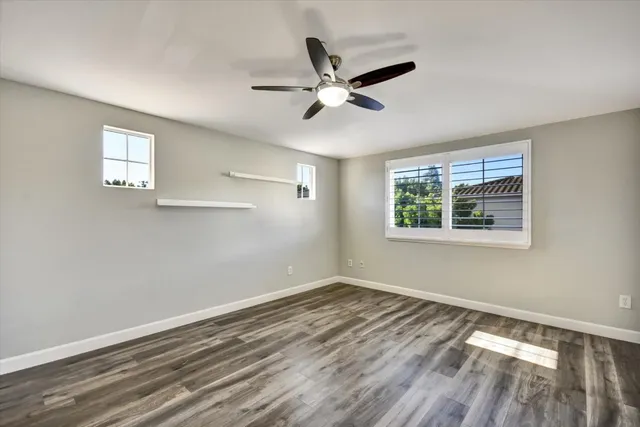 a view of a room with window and ceiling fan