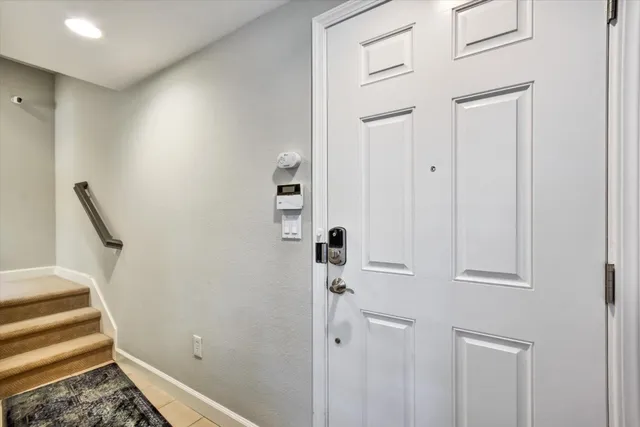 a view of a hallway with closet and front door