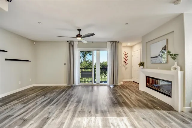 a view of livingroom with furniture a fireplace and wooden floor