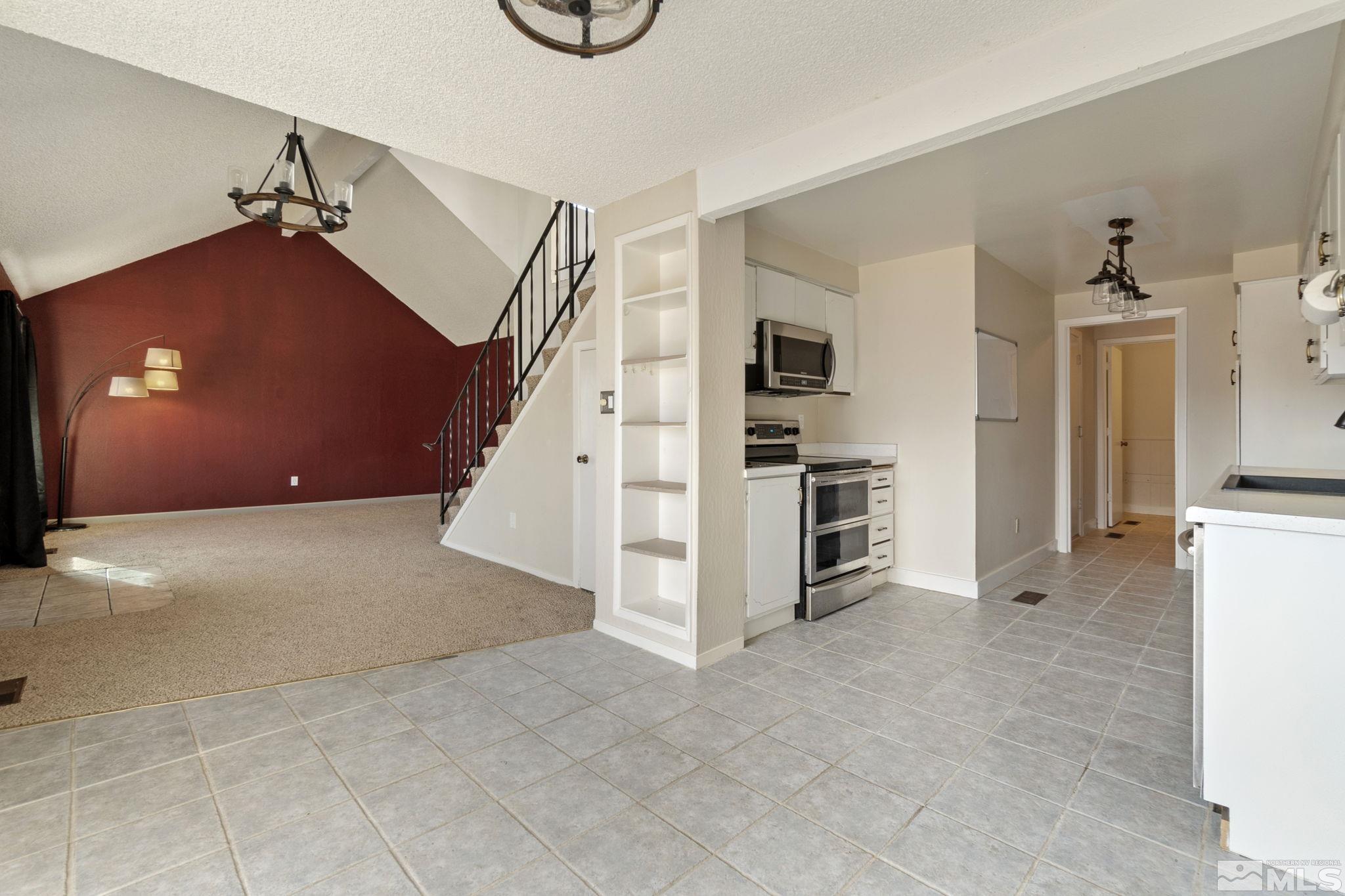 68 Condor Circle Carson City, NV 89701 - Photo 11 of 33 a view of a livingroom with a staircase and kitchen view