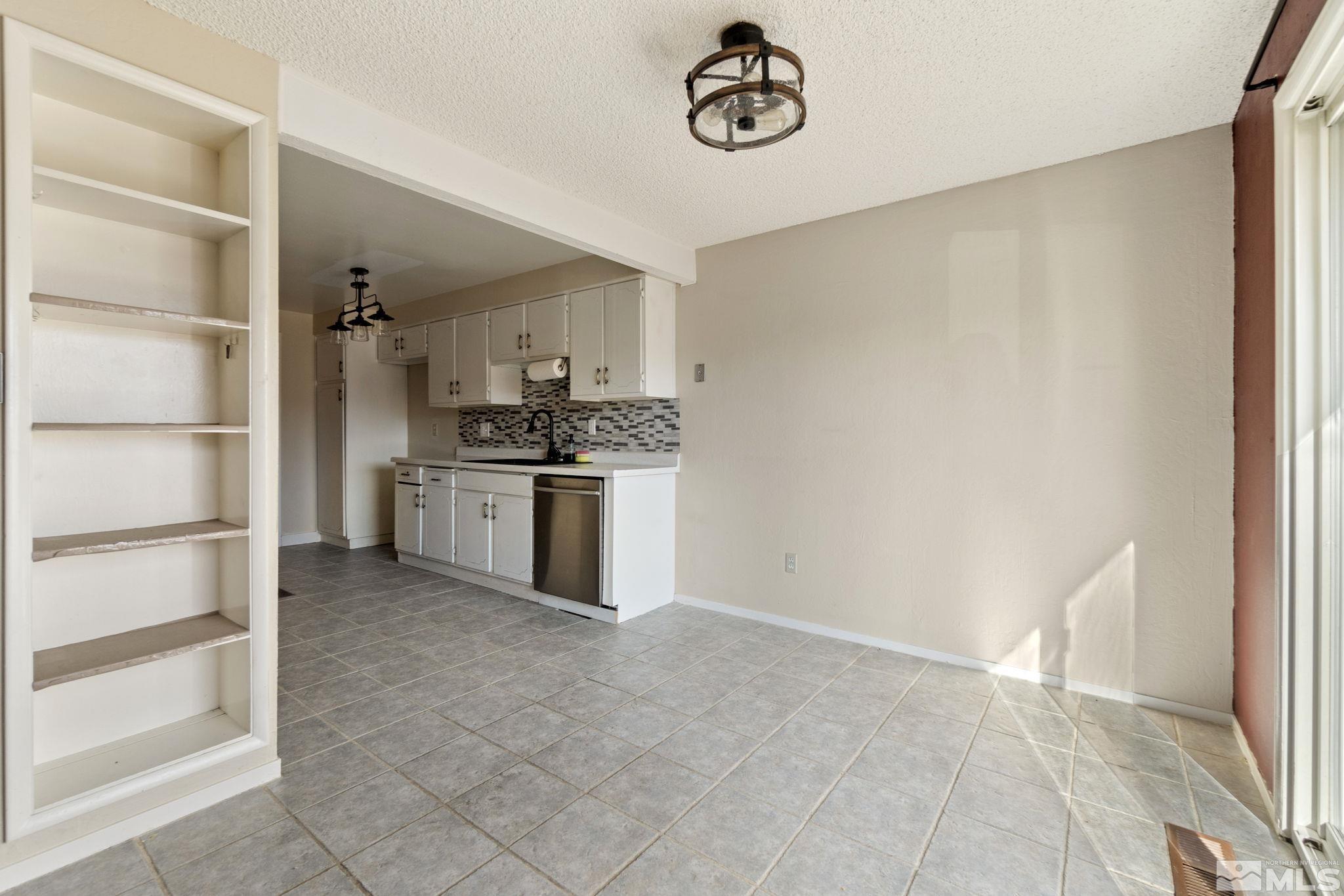 68 Condor Circle Carson City, NV 89701 - Photo 12 of 33 a kitchen with a stove top oven and cabinets