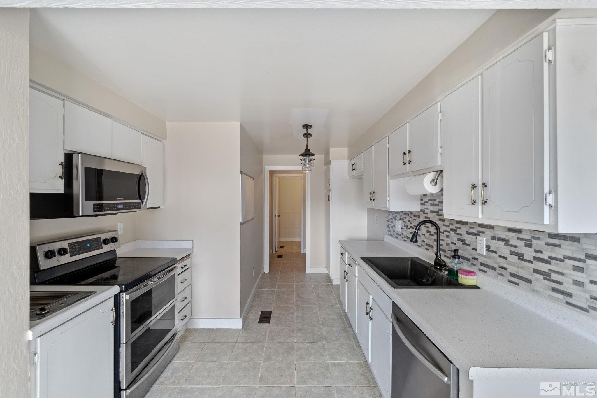 68 Condor Circle Carson City, NV 89701 - Photo 15 of 33 a large kitchen with a stove and a sink