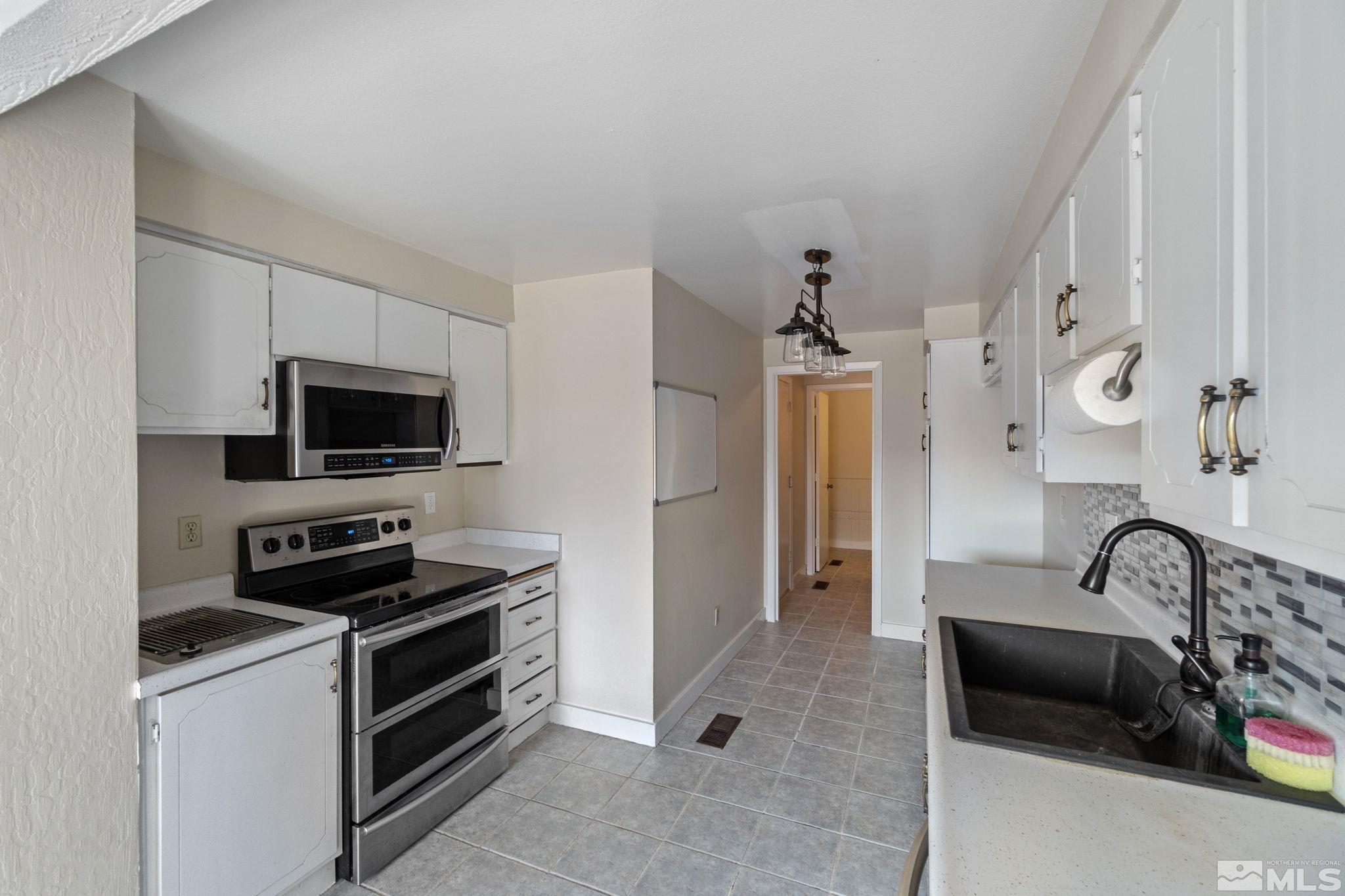 68 Condor Circle Carson City, NV 89701 - Photo 16 of 33 a kitchen that has a sink and a stove in it