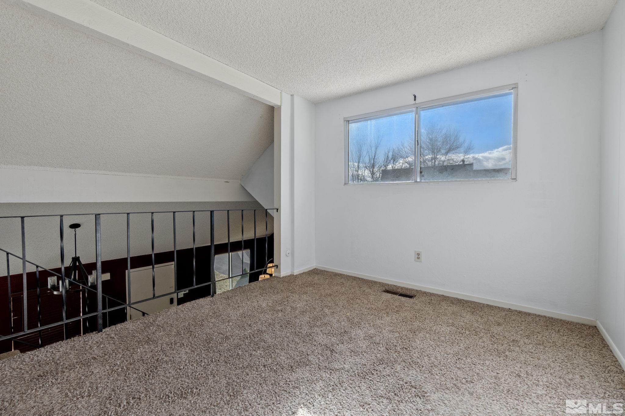 68 Condor Circle Carson City, NV 89701 - Photo 25 of 33 a view of an empty room with wooden floor