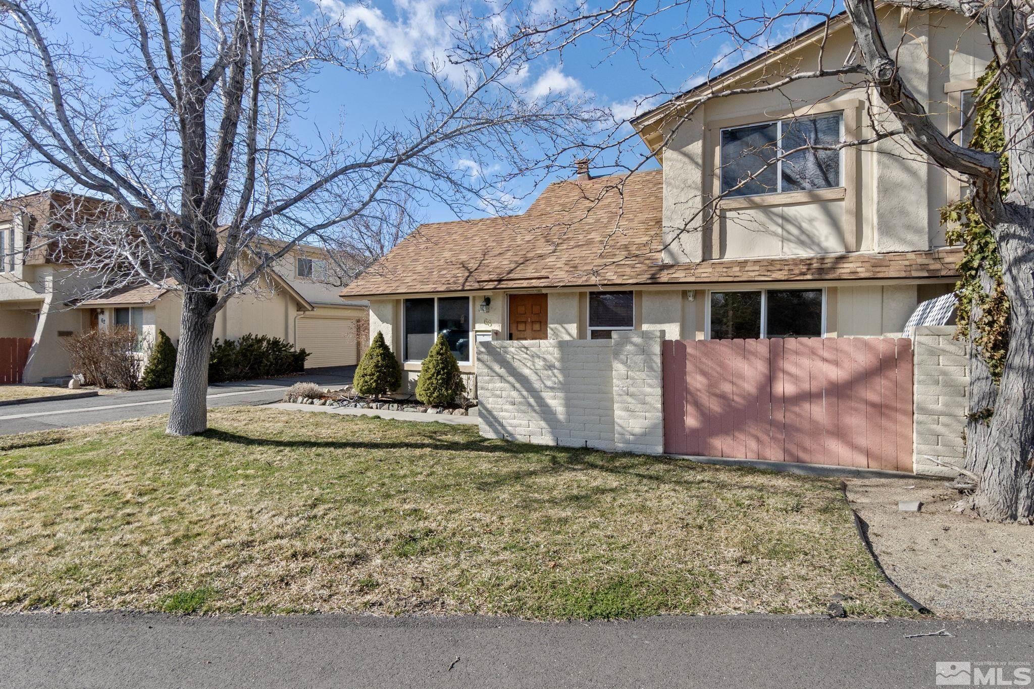 68 Condor Circle Carson City, NV 89701 - Photo 3 of 33 a view of a white house with a large tree next to a yard