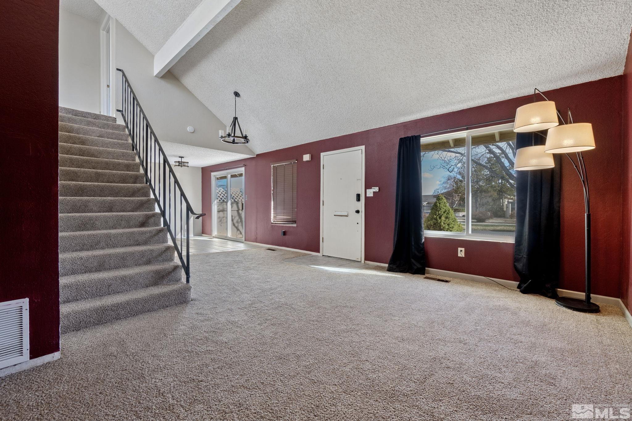 68 Condor Circle Carson City, NV 89701 - Photo 8 of 33 a view of an empty room with stairs and a fireplace