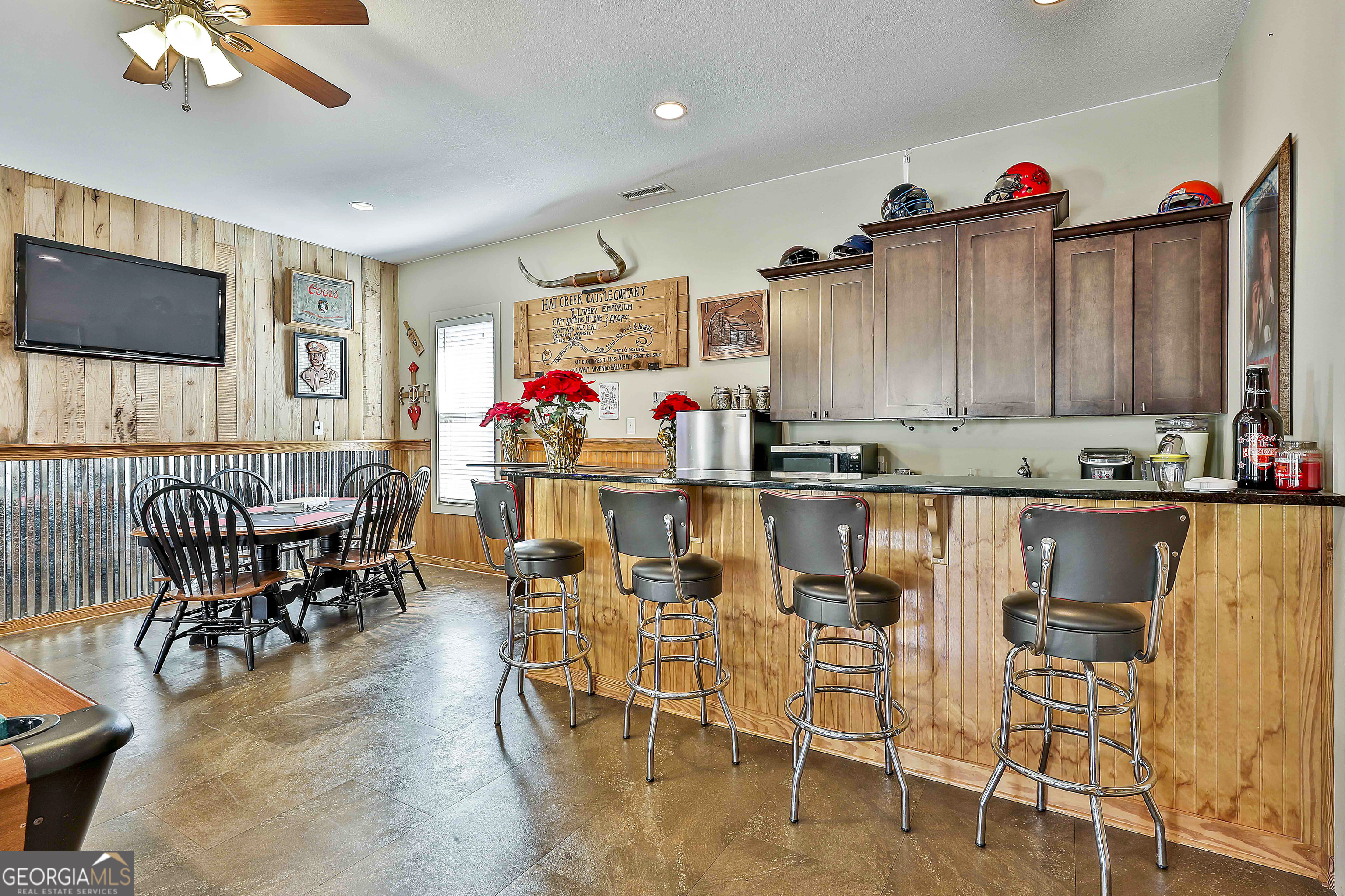 2161 Bear Creek Road Moreland, GA 30259 - Photo 103 of 137 a kitchen with stainless steel appliances kitchen island granite countertop a table and chairs in it