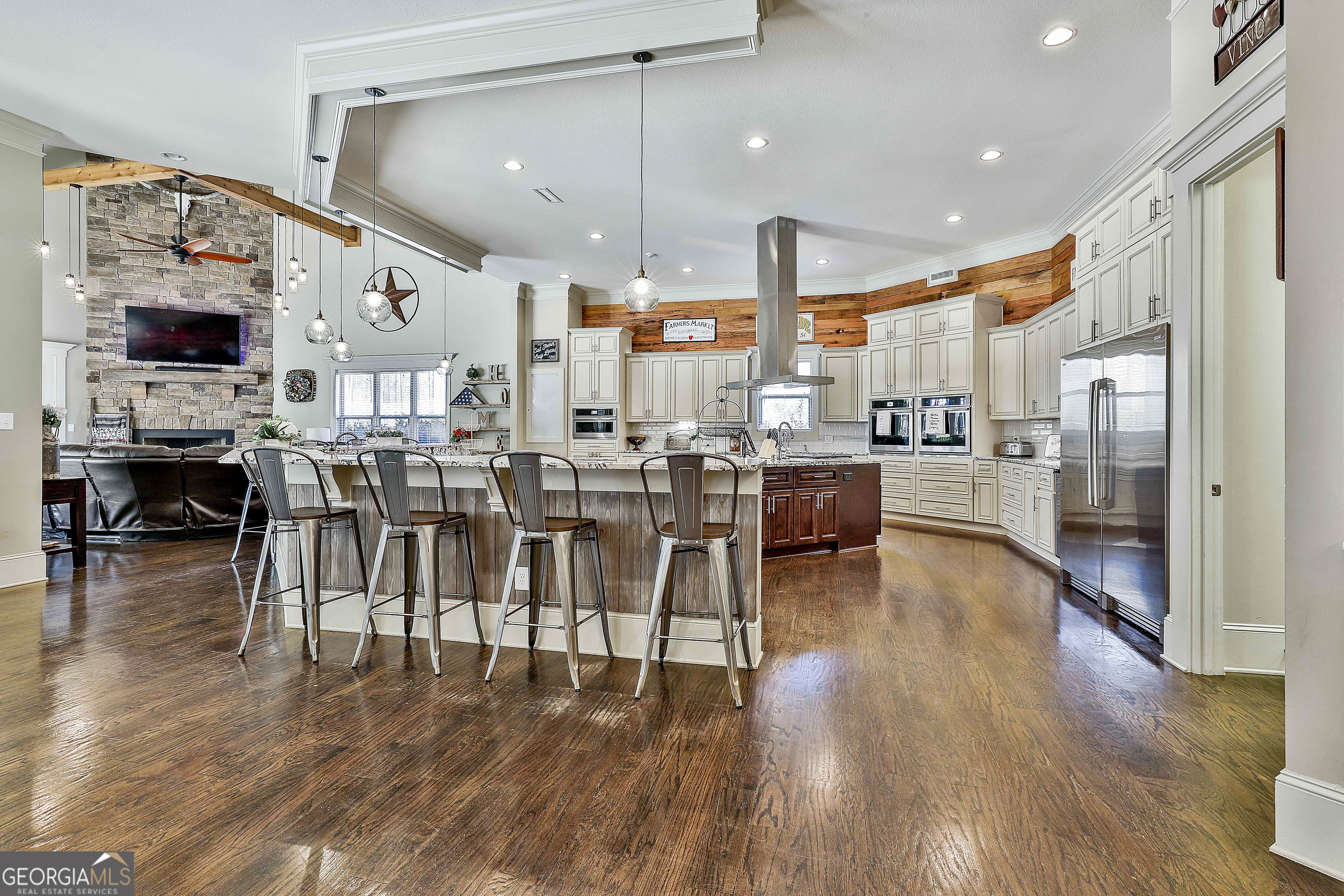 2161 Bear Creek Road Moreland, GA 30259 - Photo 32 of 137 a open kitchen with stainless steel appliances granite countertop a stove refrigerator and a dining table with wooden floor