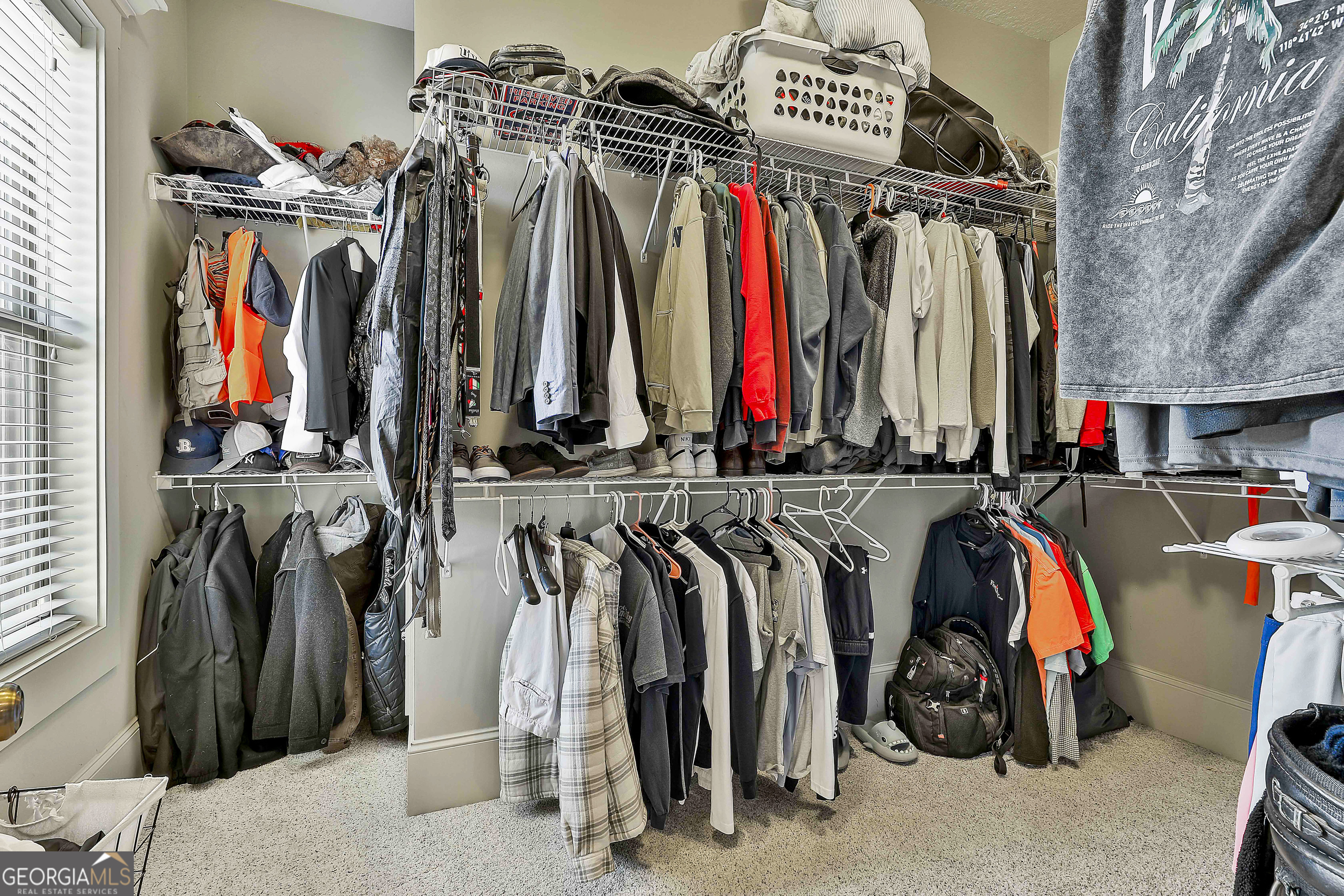 2161 Bear Creek Road Moreland, GA 30259 - Photo 58 of 137 a view of walk in closet with clothes