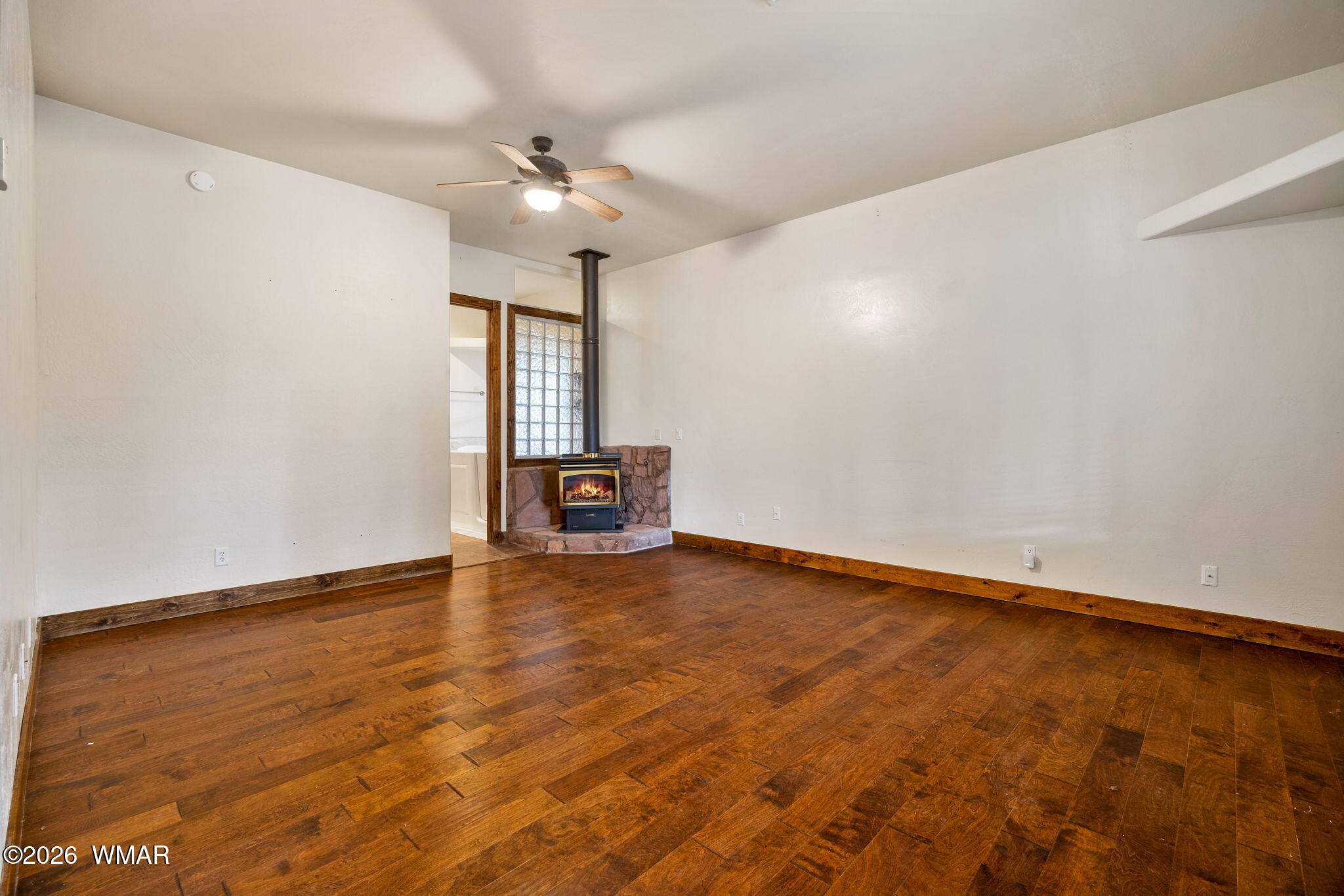 1955 Ricochet Ranch Road Overgaard, AZ 85933 - Photo 15 of 48 wooden floor in an empty room with a window