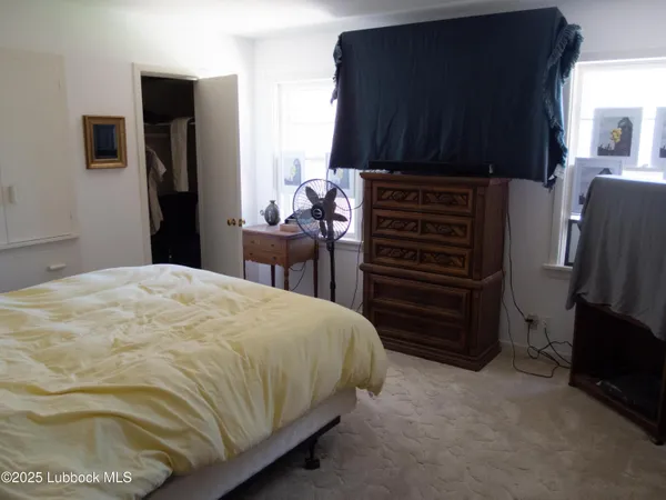 a bedroom with a bed and a television