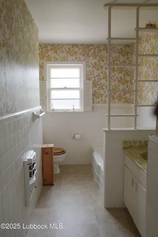 a bathroom with a toilet sink and window