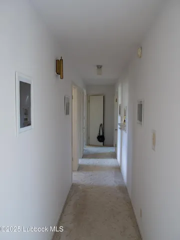a view of a hallway with a white walls