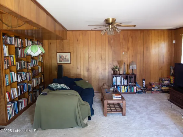 a bedroom with furniture and a book shelf