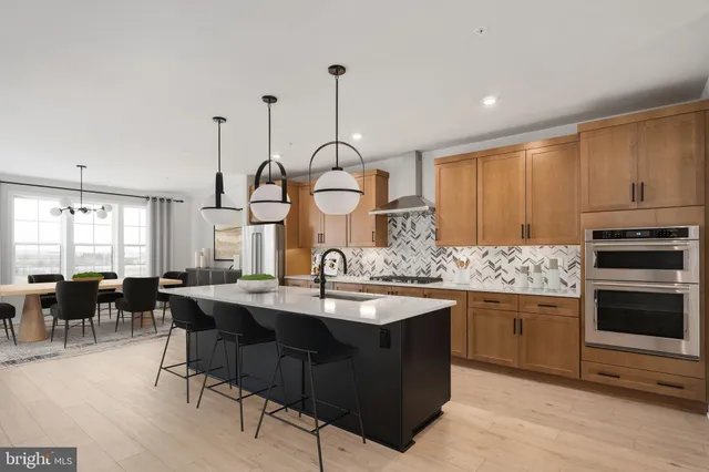 a kitchen with sink cabinets and dining table